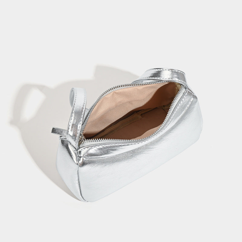 Compact curved silver metallic shoulder bag with top zip closure and slim single strap, detail view 4