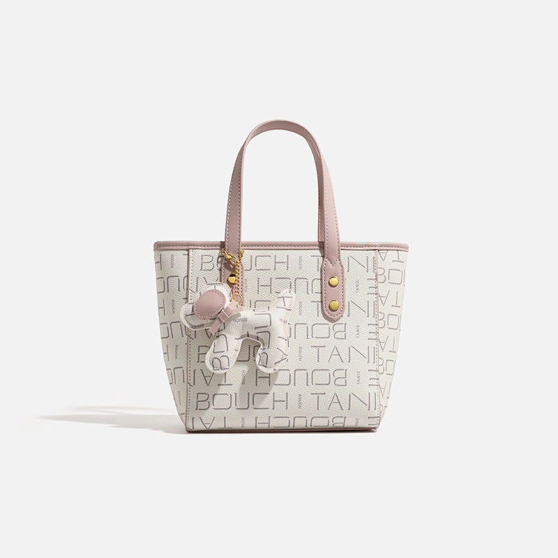 Kleine strukturierte Mini-Tote-Bag mit Logoprint, zartrosa Besatz, goldfarbenen Beschlägen, zwei oberen Henkeln und baumelndem Bärenanhänger