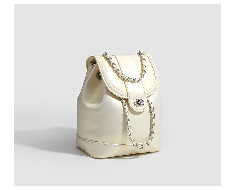 Small pearl-gloss backpack handbag with woven silver chain straps and turn-lock flap closure, detail view 12