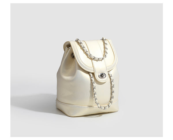 Small pearl-gloss backpack handbag with woven silver chain straps and turn-lock flap closure, detail view 12