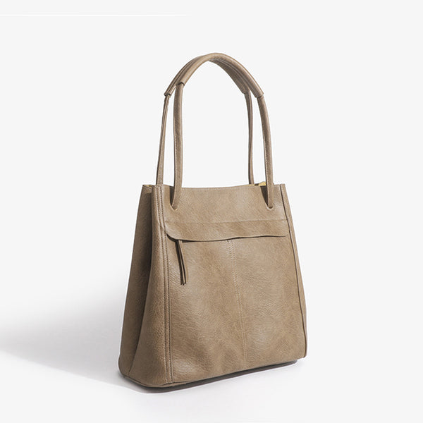 Retro structured matte leather-look tote bag in camel with front flap pocket, tassel pull, and double top handles, detail