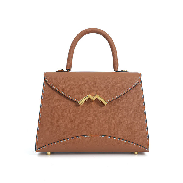 Structured trapezoid top-handle satchel in golden brown cross-grain textured finish with gold M-shaped clasp hardware and