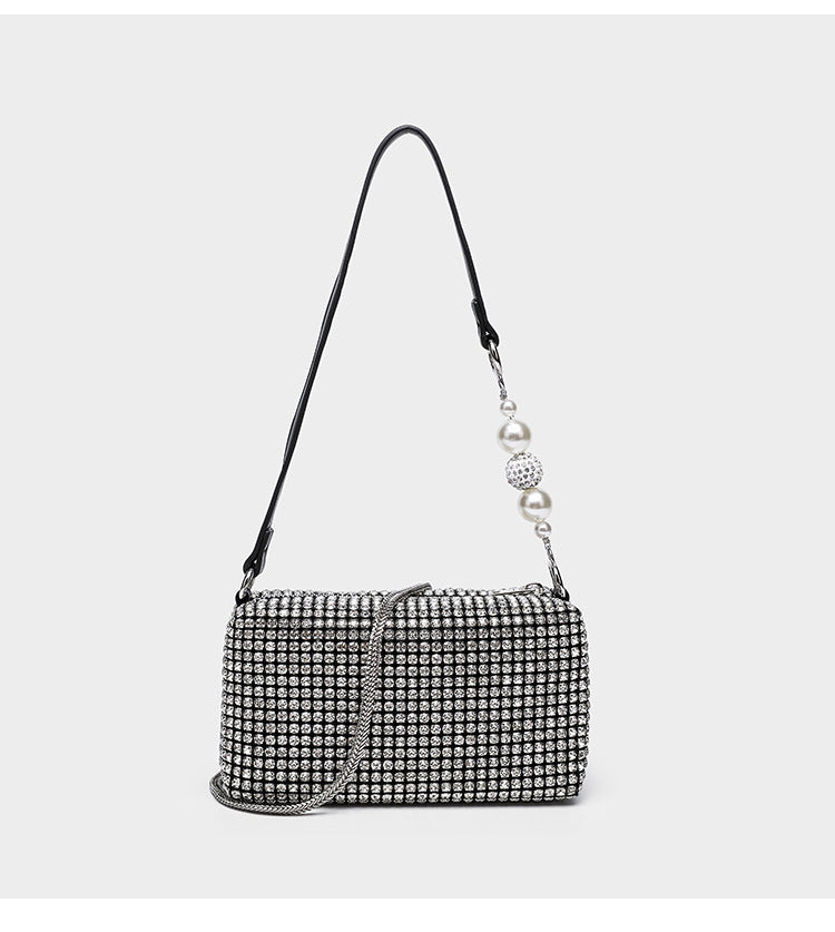 Small rectangular all-over rhinestone crossbody bag with pearl bead zipper pull and detachable silver chain strap, detail