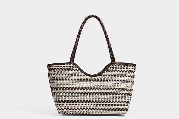 Large woven checker-pattern tote bag with dark braided shoulder straps, leather-look trim, and drawstring side ties, detail