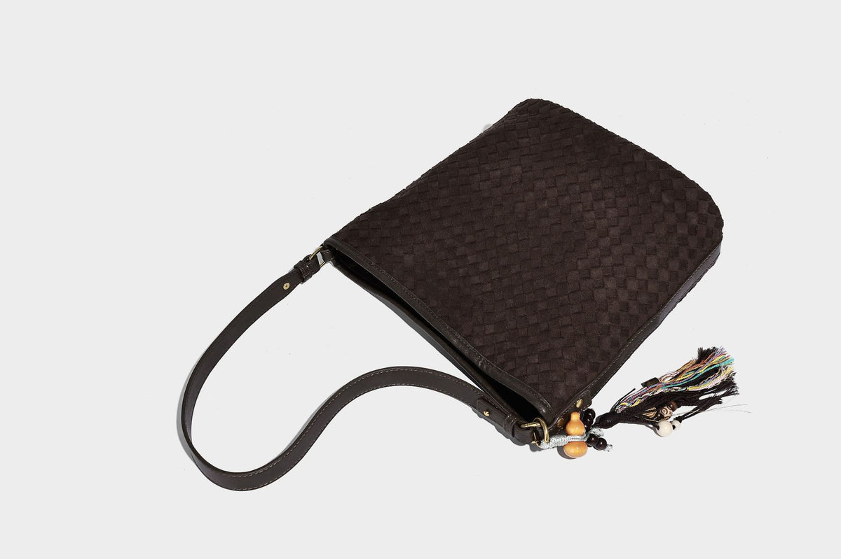 Dark chocolate woven texture hobo shoulder bag with multicolor tassel-and-bead charm and long adjustable strap, detail view