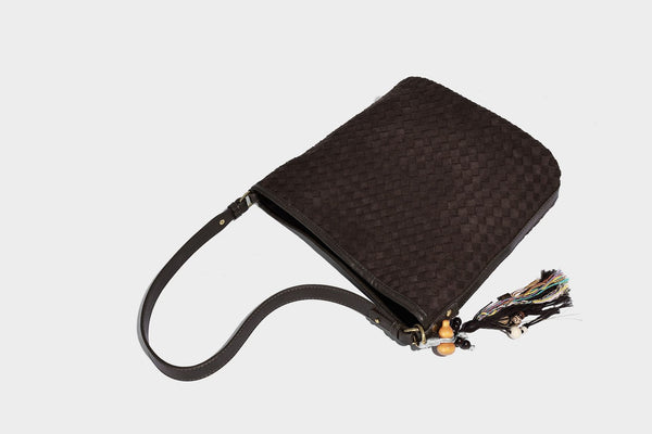 Dark chocolate woven texture hobo shoulder bag with multicolor tassel-and-bead charm and long adjustable strap, detail view