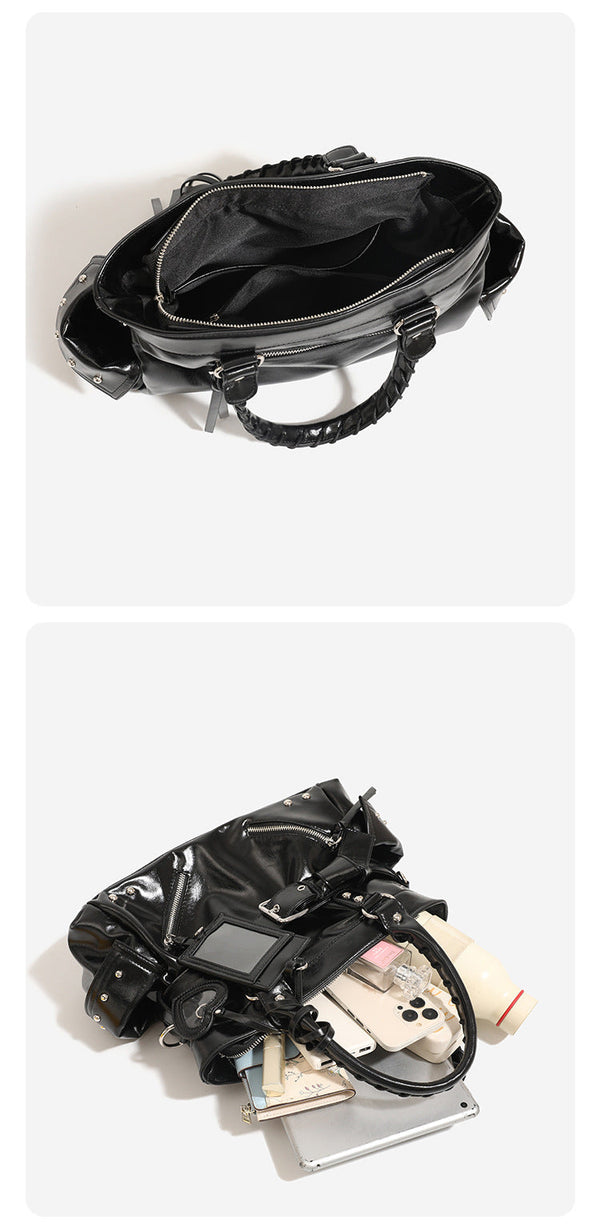 Black glossy leather-look structured tote bag with silver studs, buckle strap, exterior zip pockets, braided top handles