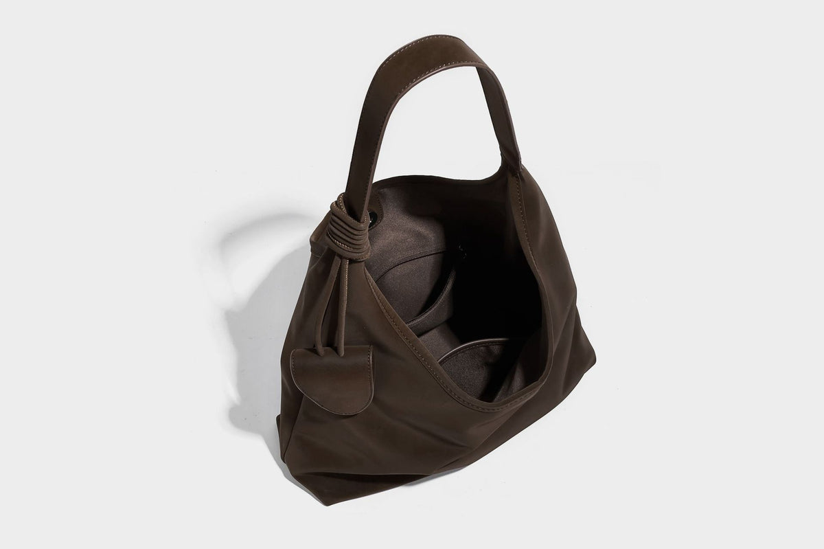Slouchy oversized matte suede-look shoulder tote bag with knotted strap and attached front flap pouch, detail view 17