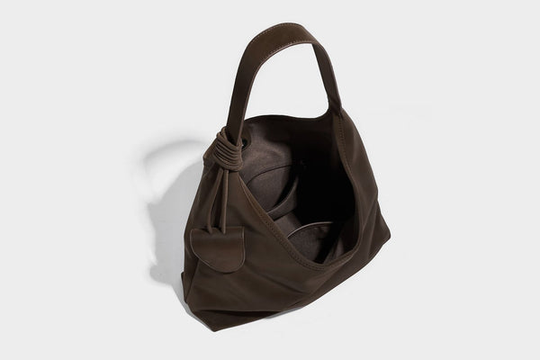Slouchy oversized matte suede-look shoulder tote bag with knotted strap and attached front flap pouch, detail view 17
