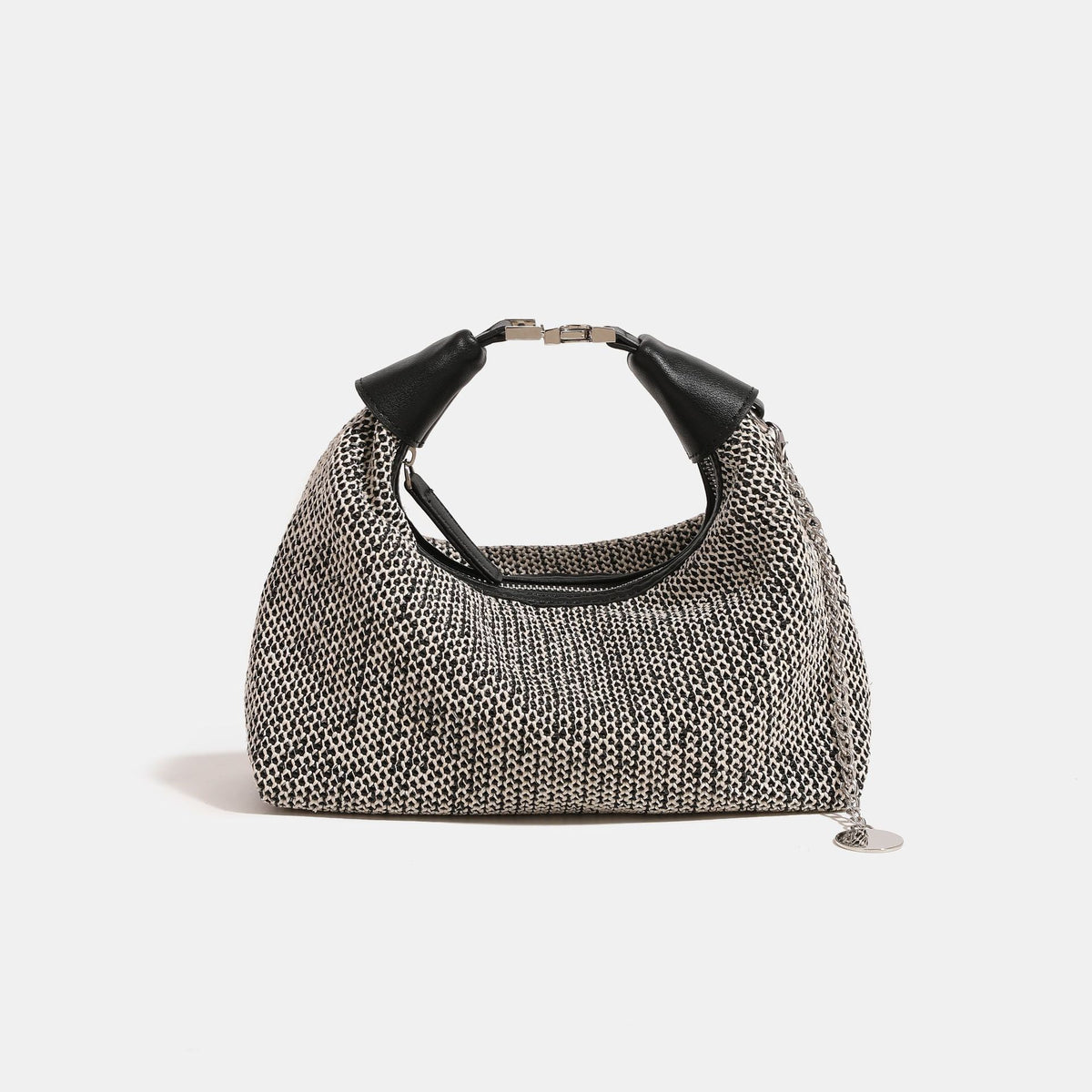 Woven straw hobo bag with leather-look knotted top handle, silver-tone hardware, and chain charm in black and tan colorways