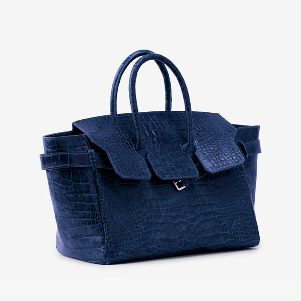 Large structured tote satchel with glossy crocodile-embossed leather-look finish, dual top handles, and metal buckle flap
