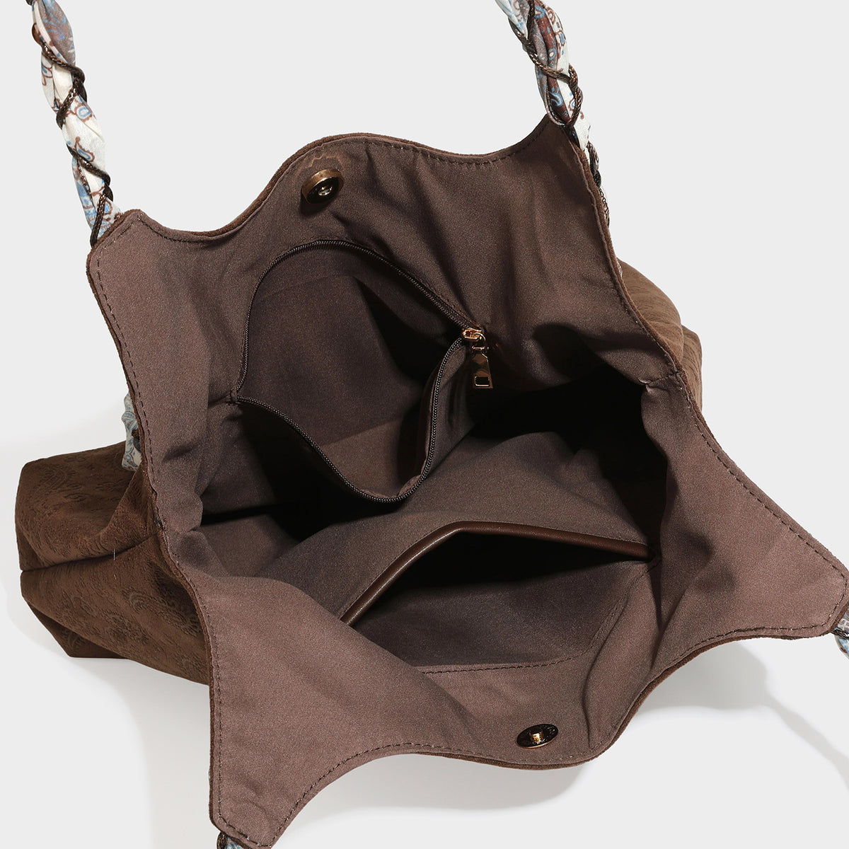 Slouchy paisley-embossed suede-look shoulder tote bag with braided patterned fabric straps and wood bead accents, detail view