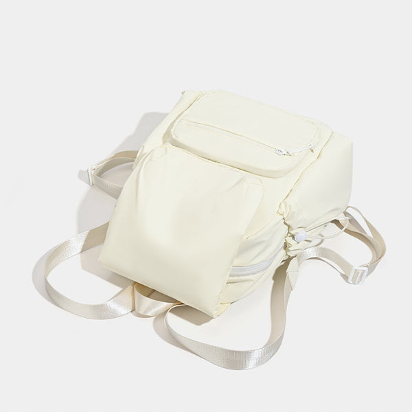 Soft matte nylon flap backpack with front zip pocket and side drawcord pockets, detail view 4