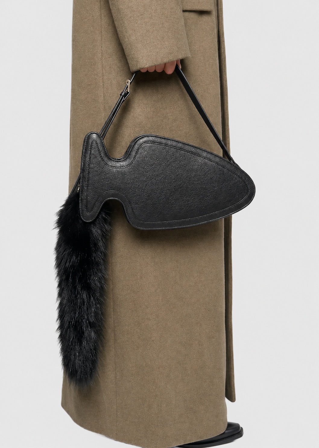 Fish-shaped pebbled leather-look crossbody bag with black faux-fur tail accent and adjustable shoulder strap, detail view 9
