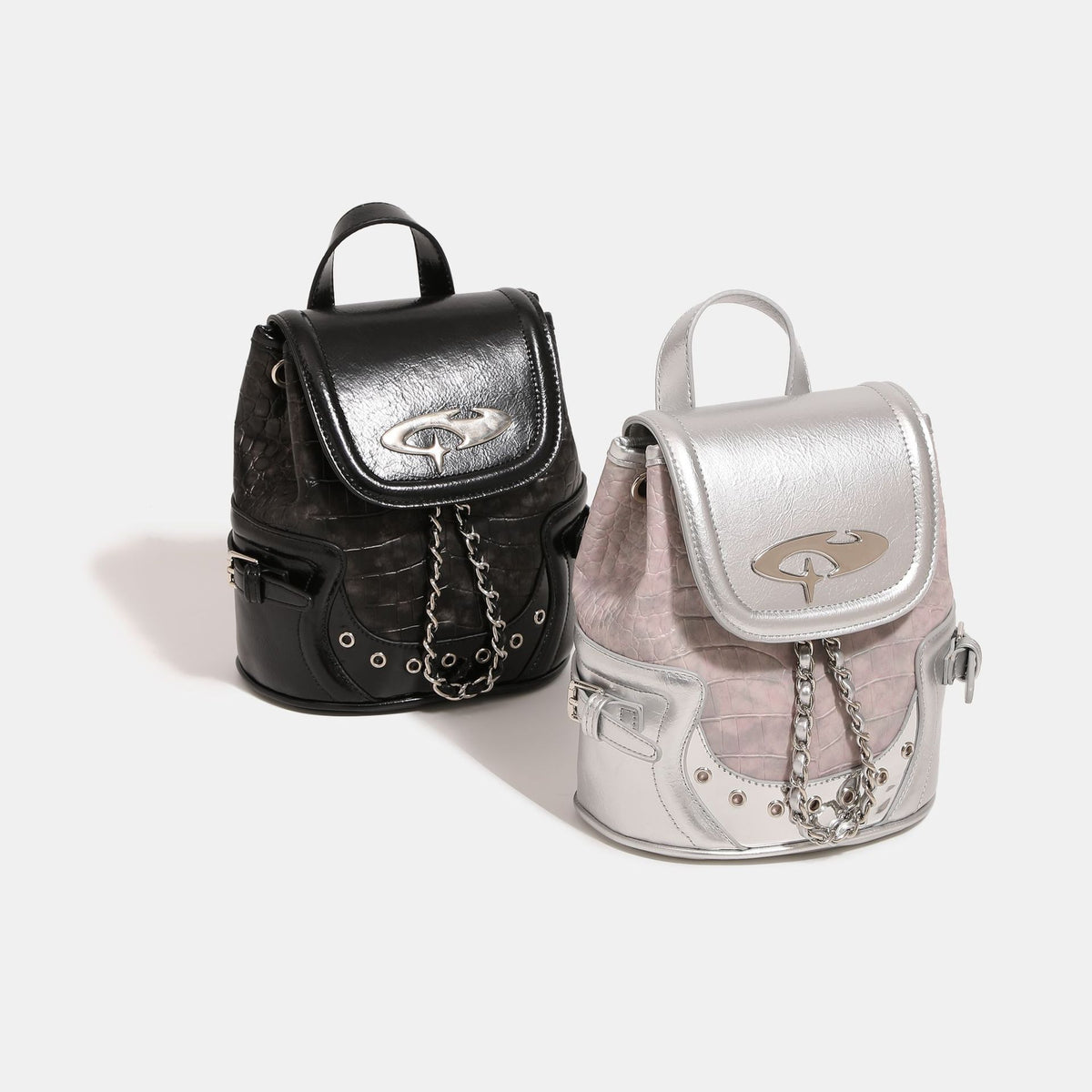 Croc-embossed mini backpack with silver metallic leather-look trim, decorative chain, and metal logo clasp, detail view 2