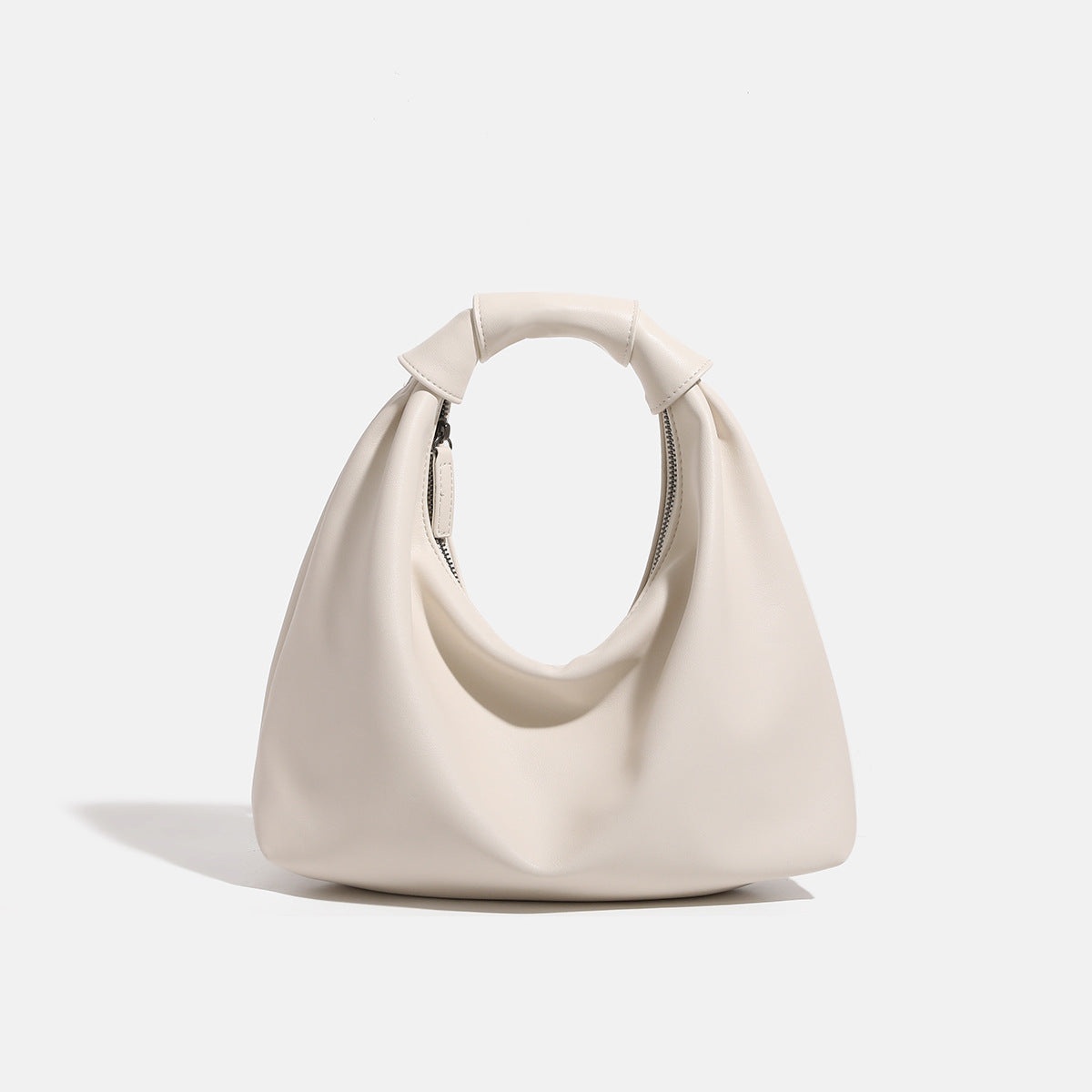 Slouchy leather-look hobo bag with knotted loop handle and top zipper closure, detail view 6