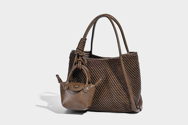 Large structured woven rope-texture tote bag with smooth leather-look trim, knotted dual top handles, detachable mini front