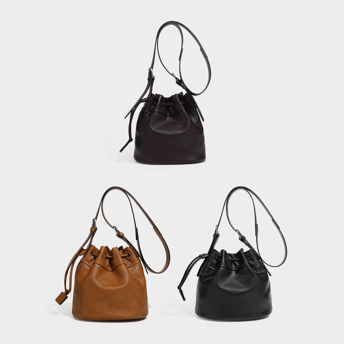 Small pebbled leather-look drawstring bucket bag with adjustable crossbody strap and silver-tone hardware, detail view 2