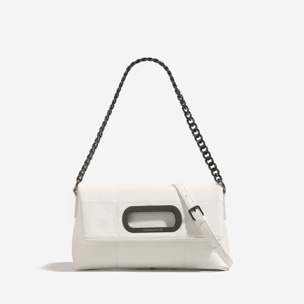 Soft rectangular leather-look convertible shoulder bag with dark curb-chain strap and rounded rectangular metal handle