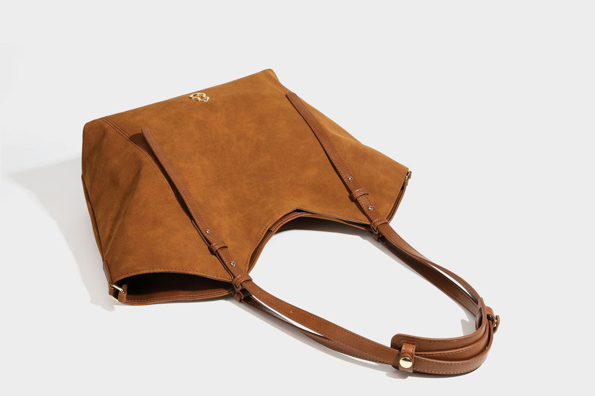 Oversized suede-finish tote shoulder bag in caramel brown with slim leather-look straps and gold-tone logo hardware, detail