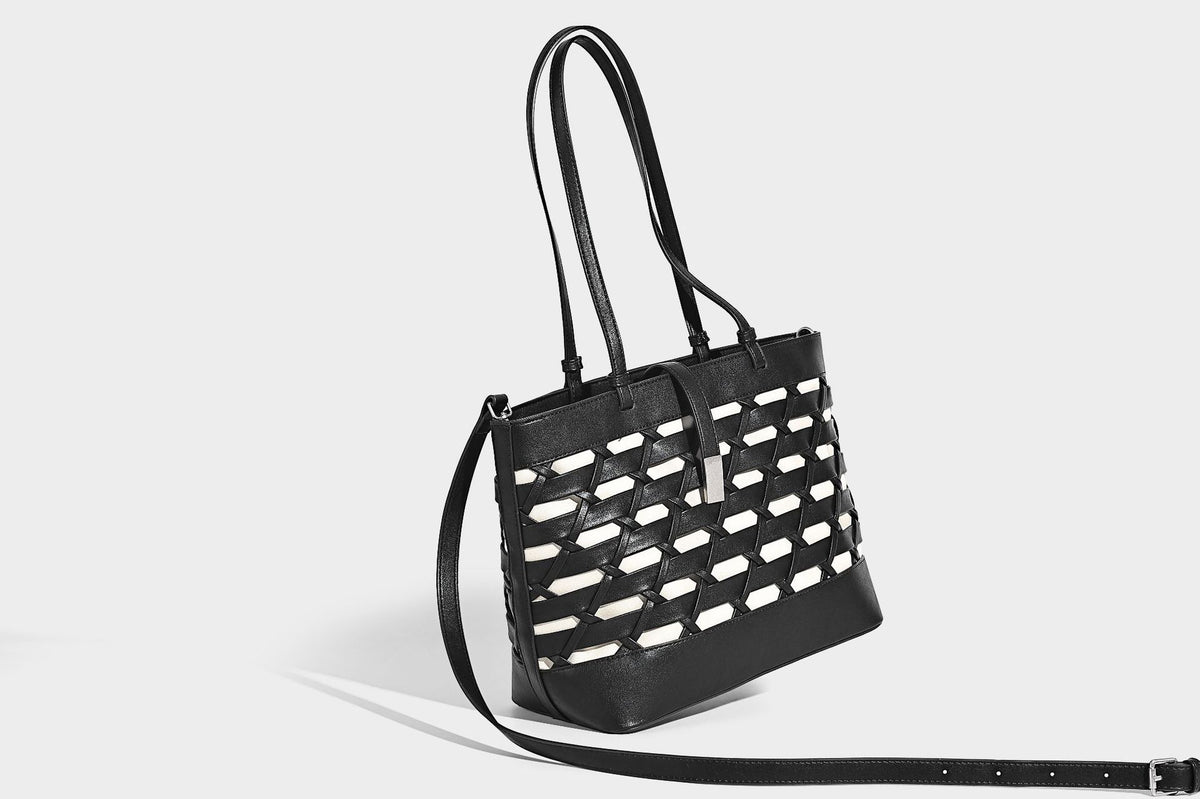 Structured woven lattice cutout tote bag with smooth leather-look trim, dual shoulder straps, and silver-tone hardware