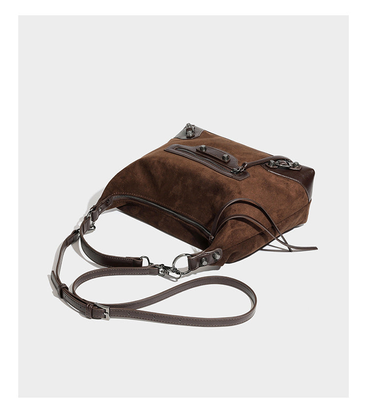 Slouchy suede-finish hobo shoulder bag with dark hardware, exterior zip pocket, tassel ties, and detachable crossbody strap