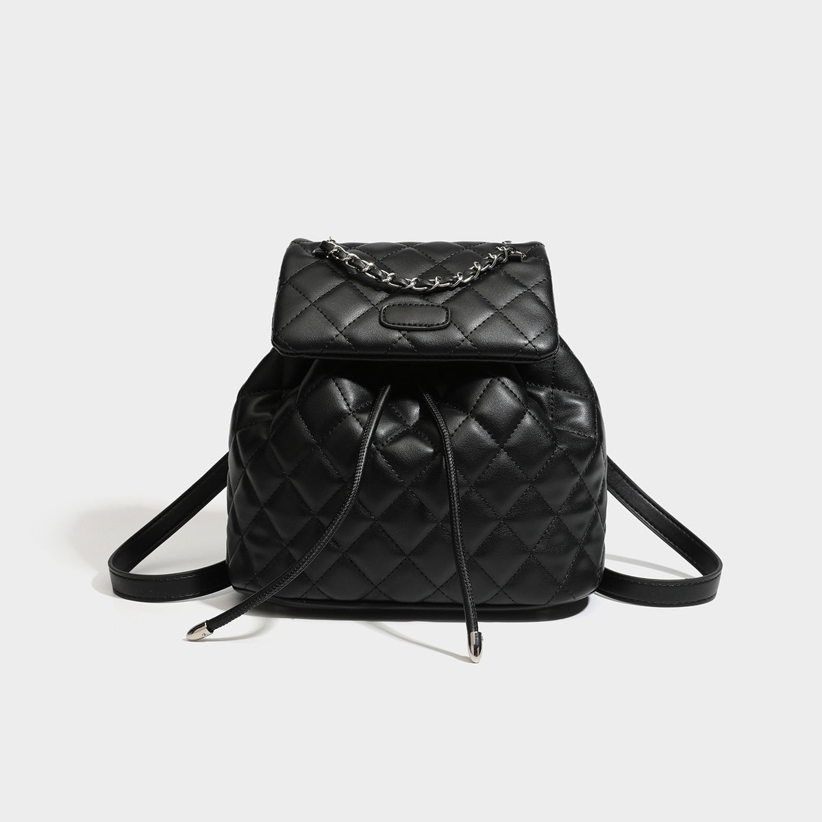 Black diamond-quilted backpack handbag with silver-tone chain flap accent and adjustable shoulder straps, detail view 6