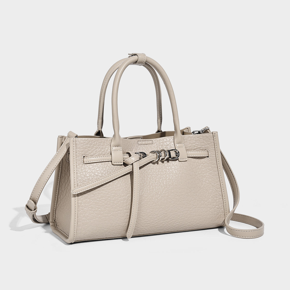 Structured trapezoid tote bag in pebbled leather-look finish with double top handles, silver-tone bar hardware, and, detail