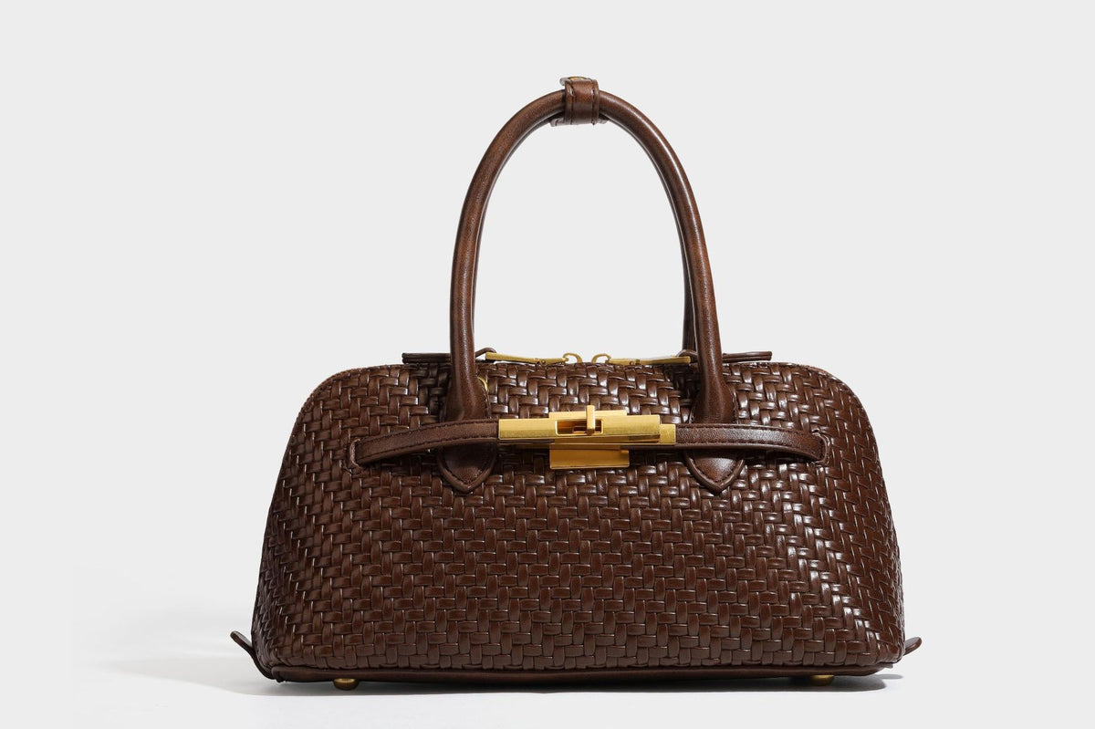 Structured woven-embossed leather-look satchel with dual rolled top handles, gold-tone turn-lock closure, and detachable