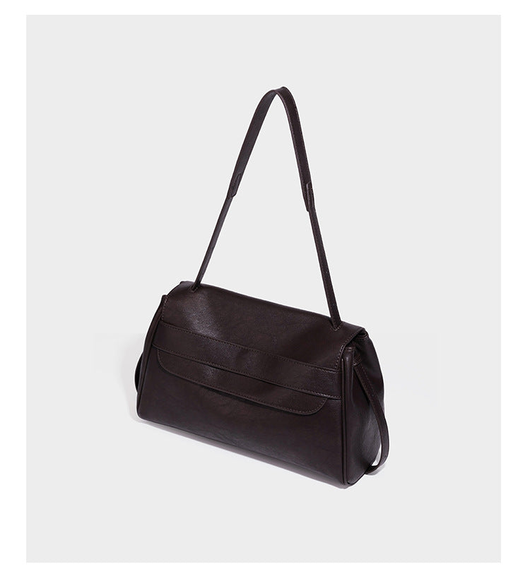 Structured rectangular flap shoulder bag in dark brown leather-look finish with long single strap and layered front panel