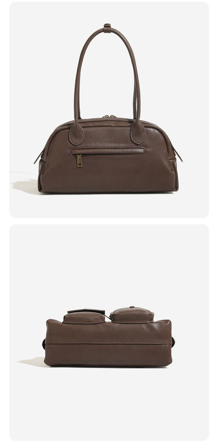 Structured retro bowling-style top-handle handbag with dual zip closure, front snap-flap pocket, and front zip pocket, detail