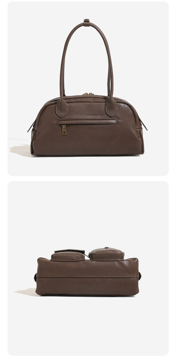 Structured retro bowling-style top-handle handbag with dual zip closure, front snap-flap pocket, and front zip pocket, detail