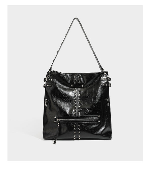 Black glossy leather-look slouchy shoulder bag with silver stud and eyelet hardware, top zip closure, front zip pocket, and