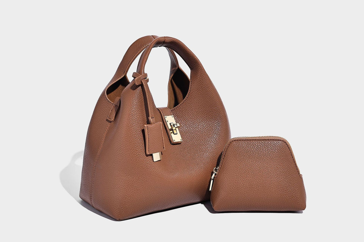 Structured pebbled-texture bucket bag with arched top handles, gold-tone turn-lock closure, and detachable shoulder strap