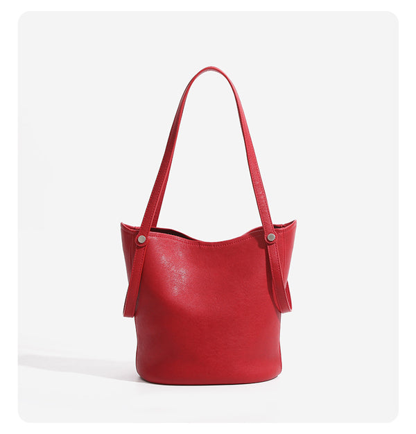 Large leather-look bucket tote bag with dual top handles and adjustable crossbody strap, detail view 13