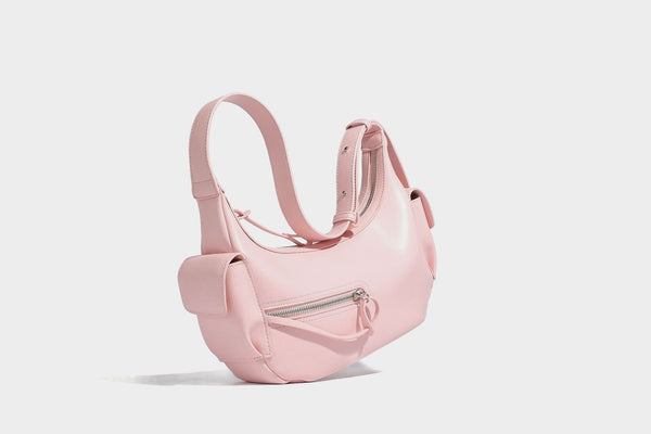 Smooth leather-look crescent shoulder bag with front zip pocket, side flap pockets, adjustable strap, and silver-tone, detail