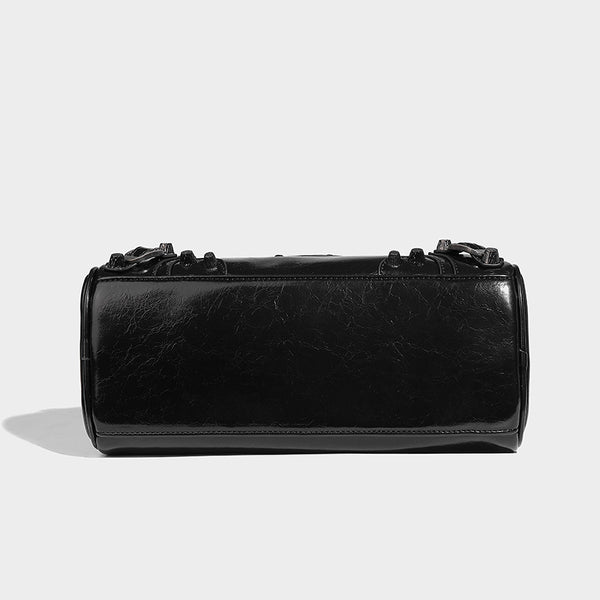 Glossy studded mini satchel bag with braided top handles, front zip pocket, heart charm, and detachable crossbody strap