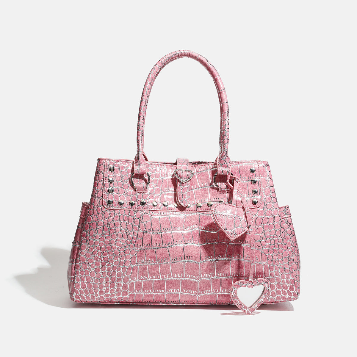 Blush pink glossy crocodile-embossed structured tote bag with studded trim, silver-tone hardware, double top handles, and