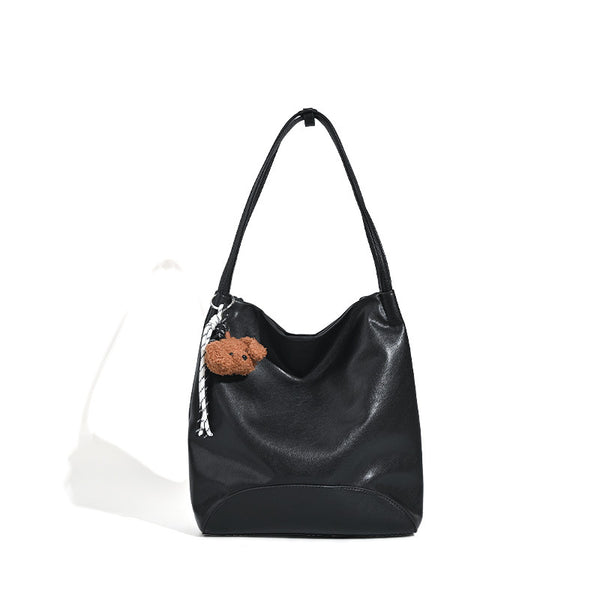 Slouchy leather-look shoulder tote with bear charm tassel in black and coffee brown, detail view 5