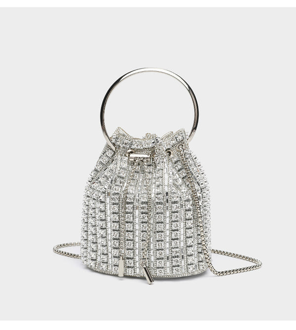 Mini crystal rhinestone bucket bag with circular ring top handle, drawstring closure, and silver chain shoulder strap, detail
