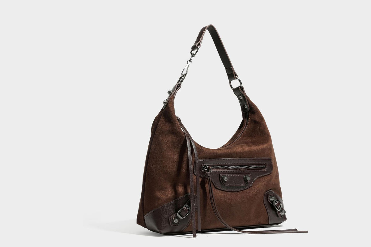 Slouchy suede-finish hobo shoulder bag with dark hardware, exterior zip pocket, tassel ties, and detachable crossbody strap