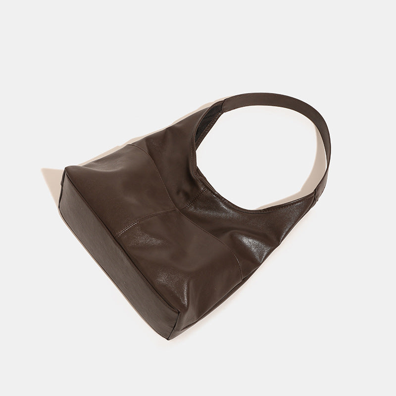 Oversized slouchy hobo tote bag in dark brown smooth matte leather-look finish with long flat shoulder strap and panelled