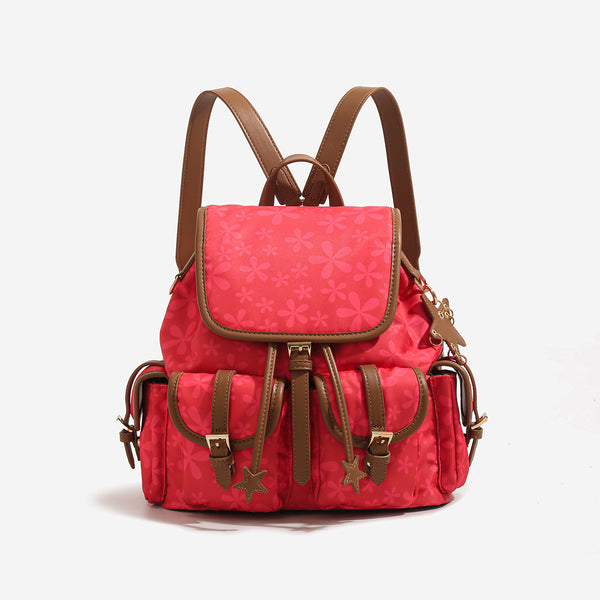 Red floral-print backpack handbag with brown leather-look trim, dual front buckle pockets, star charms, and gold-tone, detail