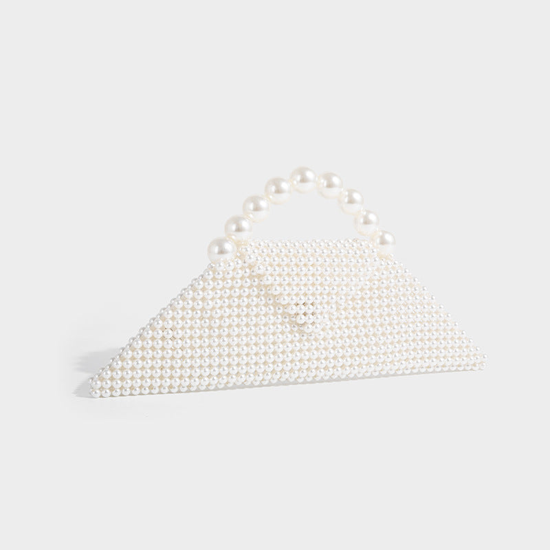 Small structured triangle clutch bag covered in glossy pearl beads with an arched pearl top handle and silver snap closure