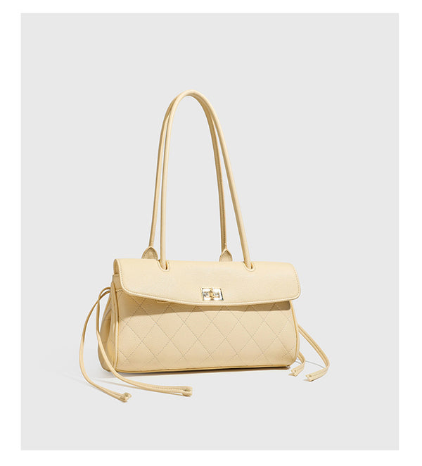 Structured black diamond-quilted shoulder bag with gold-tone turn-lock flap closure and dual round shoulder straps, detail