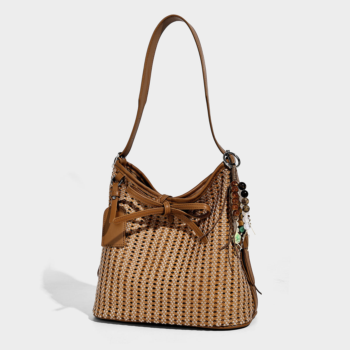 Slouchy open-weave shoulder tote bag with leather-look tan trim, tie-front closure, and long adjustable strap, front view