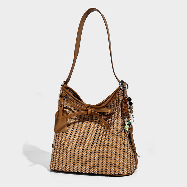 Slouchy open-weave shoulder tote bag with leather-look tan trim, tie-front closure, and long adjustable strap, front view