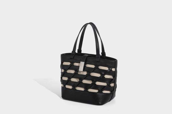 Structured woven lattice tote bag with cream lining, dual top handles, detachable crossbody strap, and silver-tone hardware