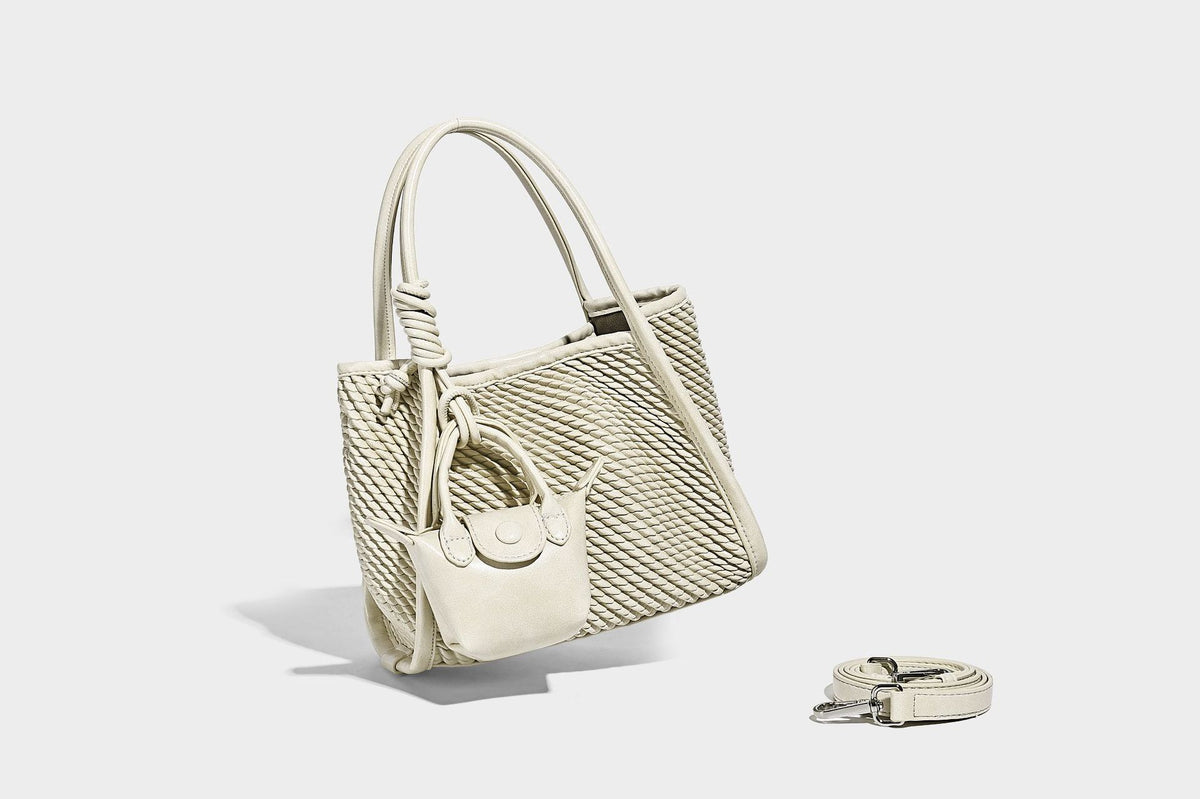Large structured woven rope-texture tote bag with smooth leather-look trim, knotted dual top handles, detachable mini front
