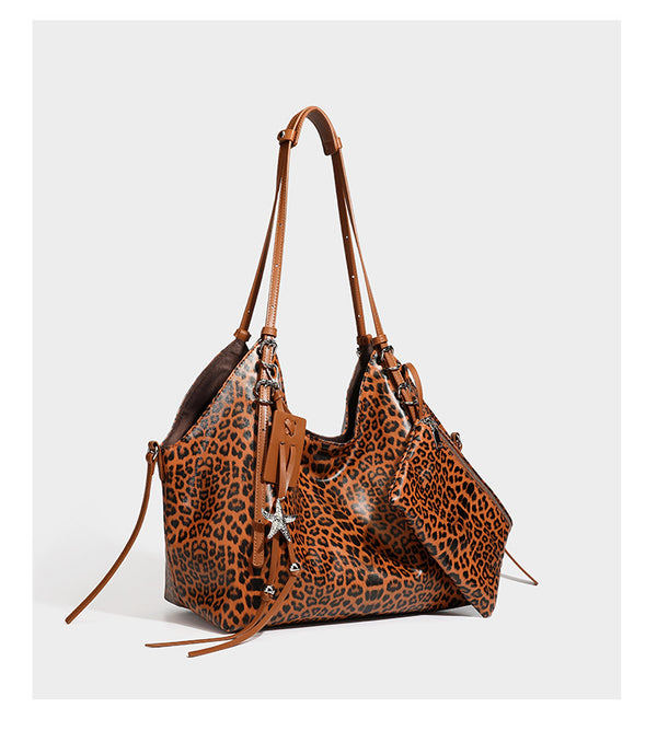 Large leopard print shoulder tote bag with glossy finish, long double straps, front zip pocket, silver-tone hardware, and